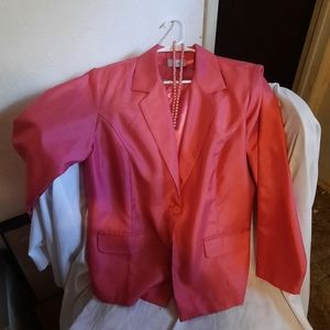 Bright coral or pink jacket and silky shirt